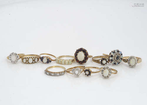 Twelve gold opal and gem set dress rings, in various settings including clusters, bands set with