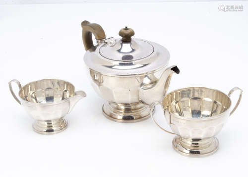 A George V silver three piece tea set by H.C Co, teapot with applied brown Bakelite style handle and