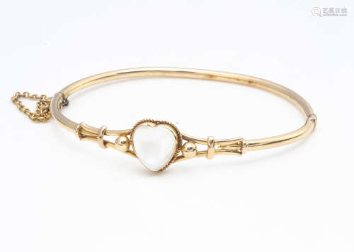 A 15ct gold moonstone set hinged bangle, the heart shaped stone within a rope twist setting with