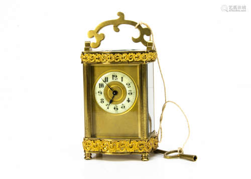 An early 20th Century French brass carriage timepiece, enamel dial, appears to run, with C scroll