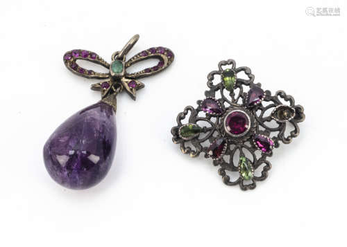 An amethyst, emerald and ruby set pendant, the tear shaped amethyst bead supported on a bow mount