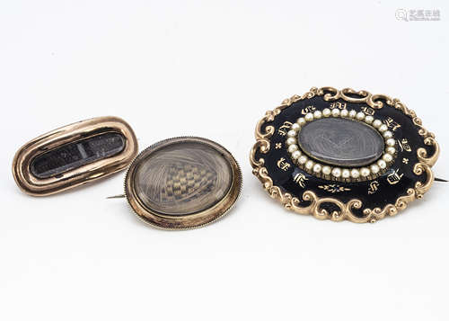 Three 19th Century mourning brooches, all of oval style centred with plaited hair panels, one with