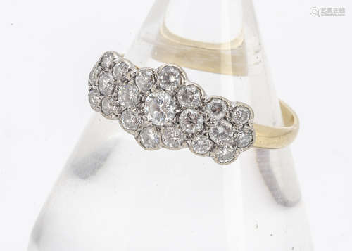 An early 20th Century diamond triple cluster dress ring, the brilliant cuts in white metal setting