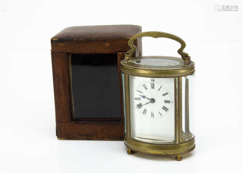 A late 19th Century brass carriage timepiece, oval form, glass panels loose, appears to run, with