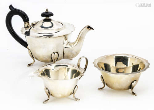 A George V silver three piece bachelors tea set from EV, shaped flared rims to teapot, sugar basin