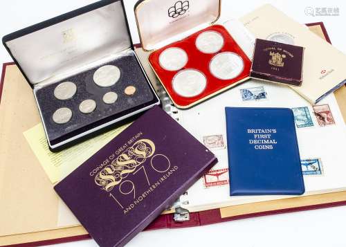 A collection of coins and stamps, including two 1976 Canadian Olympics four coins silver proof sets,