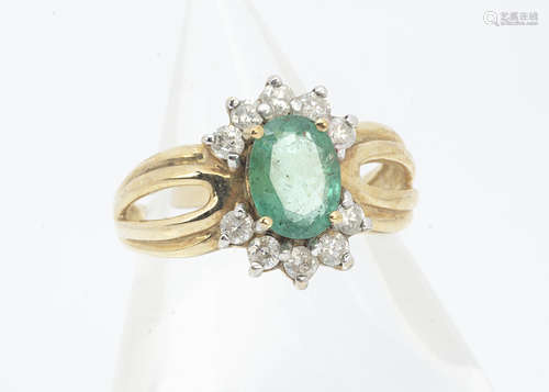 An emerald and diamond 9ct gold dress ring, the oval mixed cut with brilliant cut diamond set bezel,