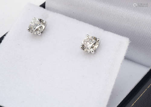 A pair of brilliant cut diamond ear studs, in claw settings, 18ct white gold, boxed, total diamond