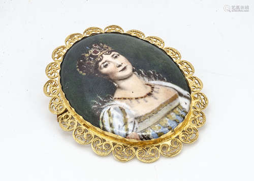 A continental yellow metal filigree mounted oval brooch, with transfer printed porcelain plaque