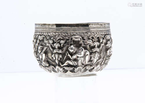 A small Burmese silver bowl, 9cm diameter, 3.6ozt, having raised design of figures in ornate