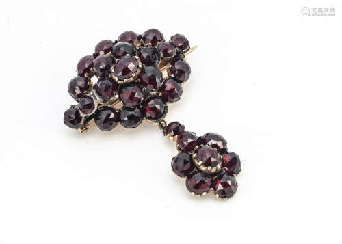 A 19th Century mixed cut garnet brooch, of oval shape with suspended drop pendant, 3.5cm x 4.5cm,