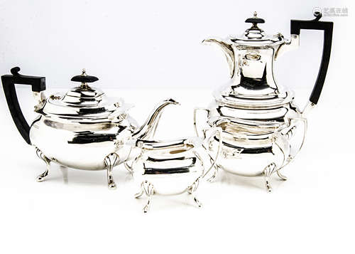 A George V silver four piece tea set by Walker & Hall, comprising teapot, hot water, sugar basin and