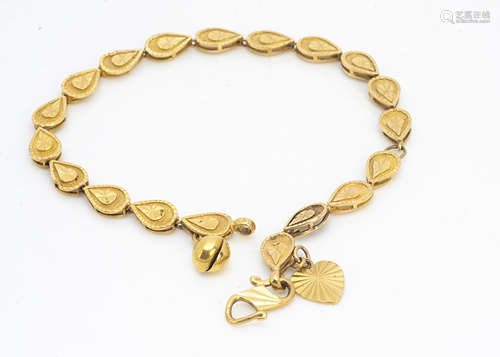 A continental yellow metal bracelet, of tear drop link design with heart and bell charm, marked