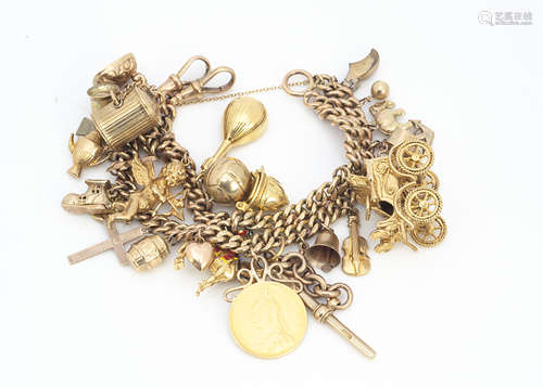 A 9ct gold large double chain curb linked charm bracelet, with multiple gold charms, mostly 9ct,