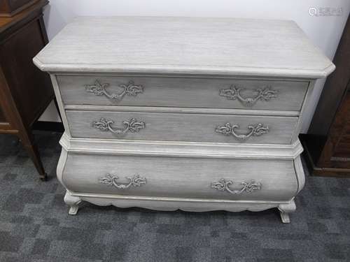 A contemporary Louis XV style bombe commode, three long drawers, distressed limed finish, possible