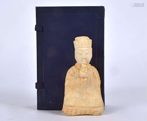 A Chinese tomb style figure, taking the form of a seated male, contained within a case, there