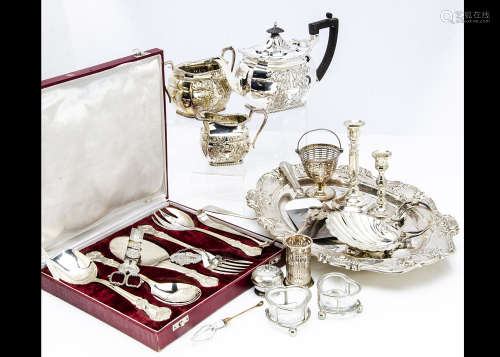 A collection of silver plate, including a three piece tea set, a meat dish, a double wine bottle