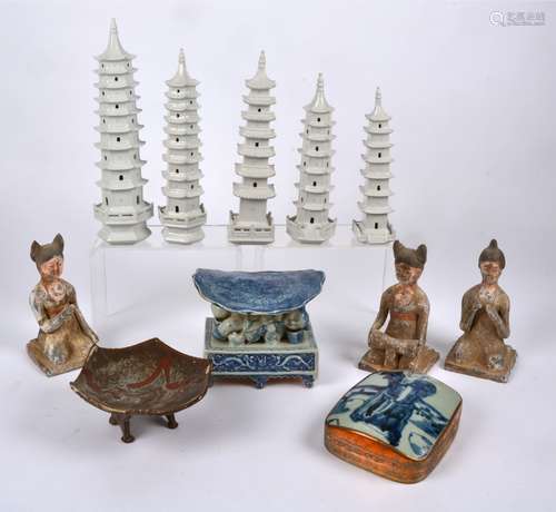 Three Chinese Tang style earthenware figures of kneeling female attendants, each with a slightly