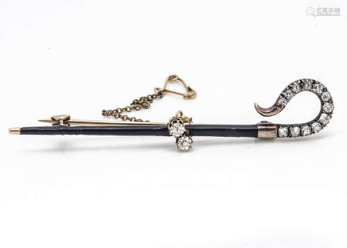 A 19th Century gold and enamel diamond set shepherd's crook bar brooch, with old cut stones set in