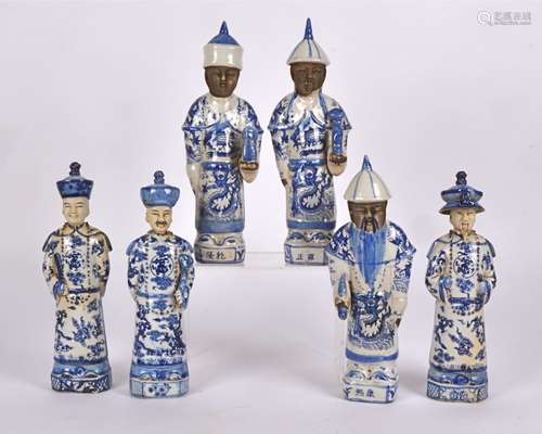 Six 20th Century Chinese figures in two groups, each figure with long plaited hair, caps and blue