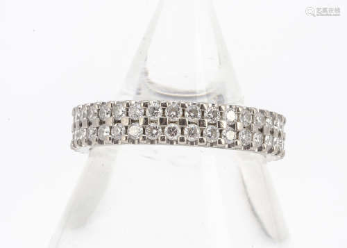 An 18ct gold double diamond band eternity ring, the claw set brilliant cuts all in white gold,