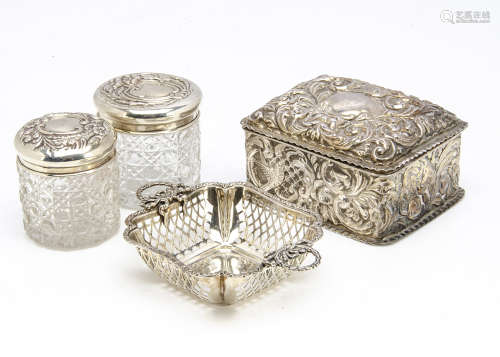 A late Victorian silver dressing table box, together with two cut glass and silver topped pots,