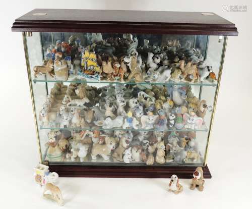 A large collectors' cabinet filled with Wade Whimsies, the figure including Disney figures such as