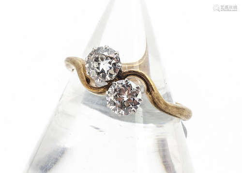 An 18ct gold and platinum set old cut diamond crossover ring, each stone approximately 0.40ct, in