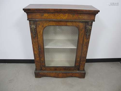 A 19th Century walnut veneered and marquetry inlaid cabinet, single glazed door, upholstered