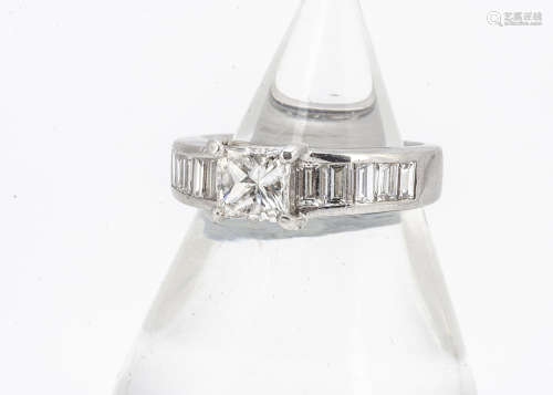 A continental 18ct white gold princess cut solitaire diamond, with baguette channel set shoulders,