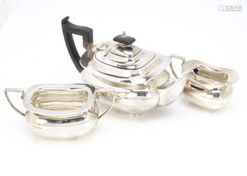A George V silver three piece tea set by Walker & Hall, teapot with applied black handle and finial,
