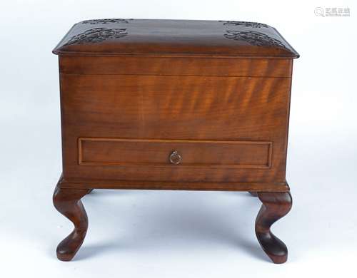 A hardwood box raised on four feet, opening to reveal one large compartment, the top with four