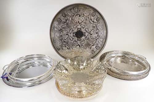 A quantity of silver plated wares, predominantly circular trays, pierced and with scrolling