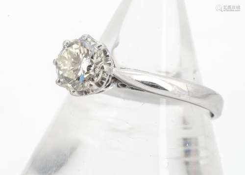 An 18ct gold diamond solitaire, the brilliant cut in eight claw setting on crown gallery with scroll