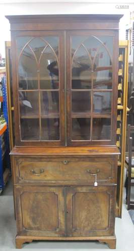 A 19th Century mahogany secretaire bookcase, moulded cornice, over gothic glazed doors, the interior