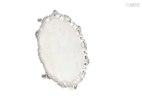 A 1970s silver salver from Mappin & Webb, having shaped edge with shell and egg and dart decoration,