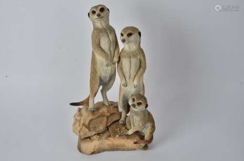 A cast group of Meercats, with a label to the base 
