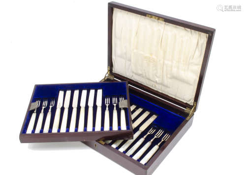 A George V part set of silver and mother of pearl dessert knives and forks from Mappin & Webb, in