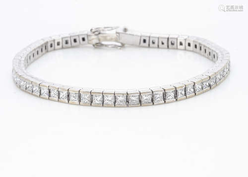 An 18ct white gold diamond line bracelet, the fifty nine princess cut diamonds in an articulated