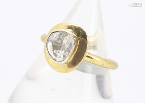 A contemporary silver gilt and diamond slither dress ring, the rubbed over diamond setting on a