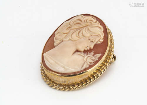 A 9ct gold and shell cameo oval brooch or pendant, the carving depicting the profile of a young girl