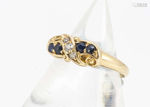 An 18ct gold sapphire and diamond Edwardian dress ring, the pairs of blue sapphires either side of