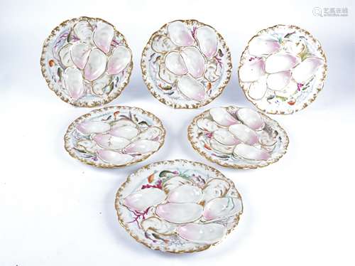 A group of nine late 19th Century or early 20th Continental porcelain oyster dishes, moulded with