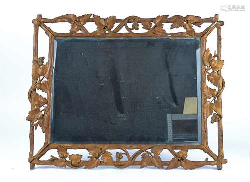 An early 20th Century mirror in carved giltwood frame taking the form of vines and grapes, with