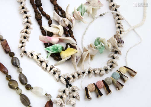 A collection of various hardstone, seed and shell necklaces, in segmented tray