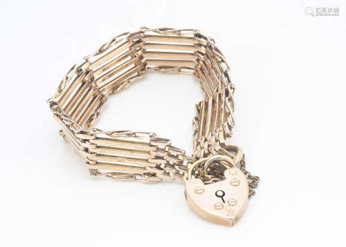 A six bar and heart padlocked clasped gate bracelet, in 9ct gold, with safety chain, 18cm long, 17.