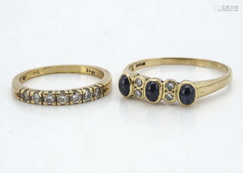An 18ct gold diamond seven stone ring, the brilliant cuts in claw setting, ring size I, together