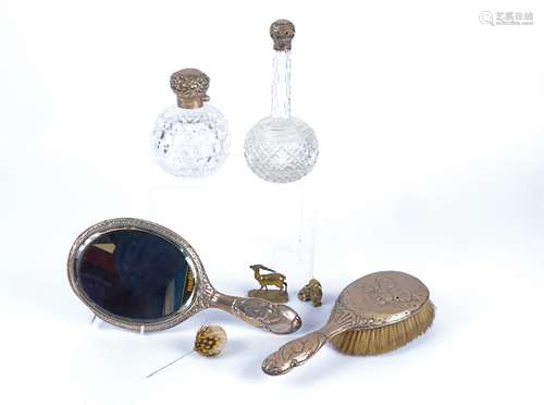 A hallmarked silver dressing table brush and mirror, with repousse work of cherubs, together with