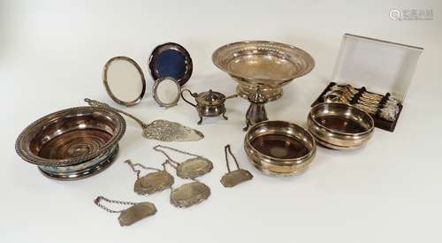 Two hallmarked Birmingham silver wine bottle coasters, together with two hallmarked silver labels