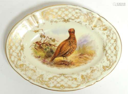 A 19th Century Royal Worcester oval plate, painted with a study of a pheasant with a gilt